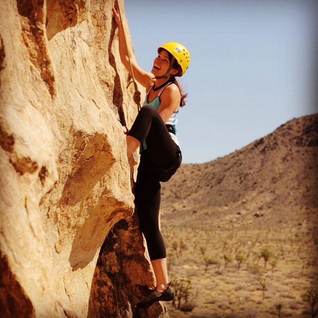 Happy desert climber in Joshua Tree National Park. Flake and Bake wall is steep with lots of features and crack lines. For many it's most challenging to get over the first shelf that that stretches across the entire wall. Once up there you get rewarded with great holds on finest Monzogranite.