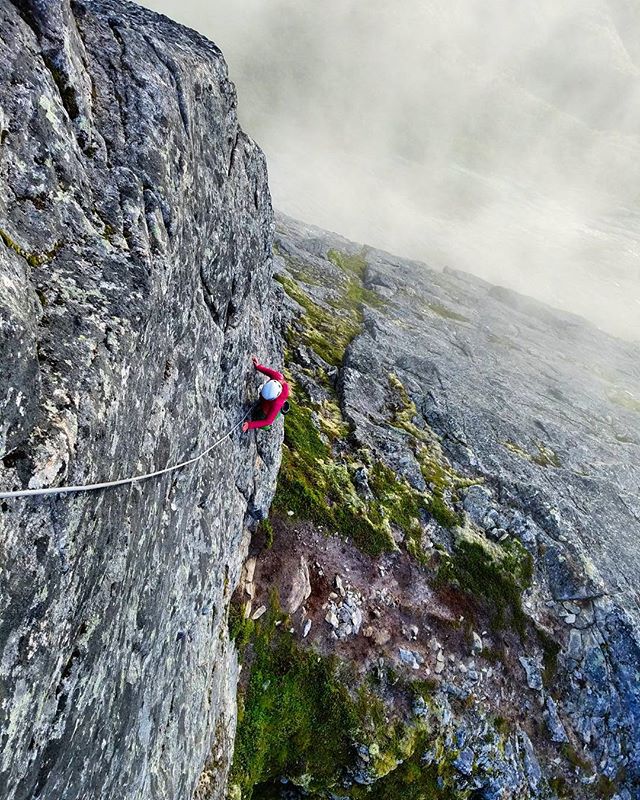 Norway is a dream country for climbers (when dry ;) We just managed to stay dry on this mystical day of clouds, sun, mist, wind and tranquility.The Stratatind traverse was our perfect venue to experience what climbing in Norway can be like. Here @katerina_tazlarova busting out another beautiful section of climbing on the ridge line.